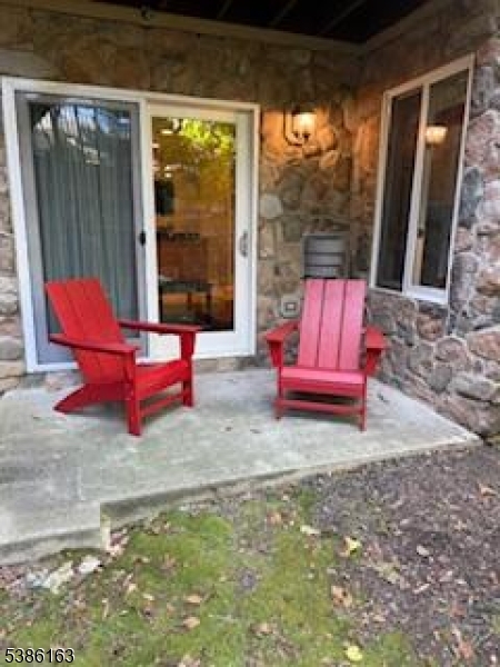 2 Chamonix Drive, Unit 212 Vernon, NJ 07462 - Photo 3 of 21 a living room with rug floor to ceiling windows and a rug