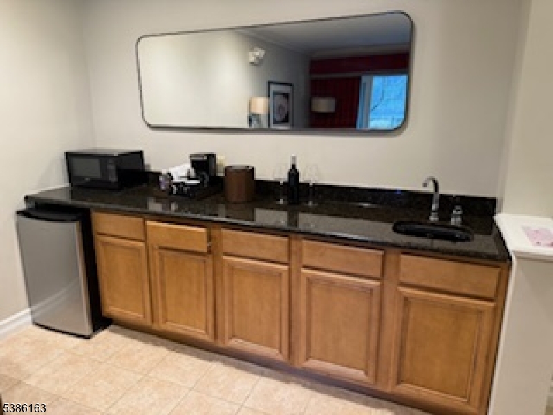 2 Chamonix Drive, Unit 212 Vernon, NJ 07462 - Photo 9 of 21 a bathroom with a sink and a mirror