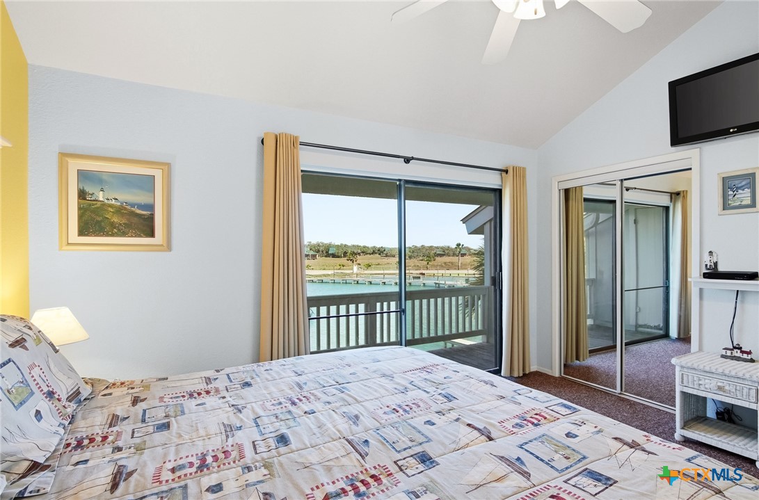 2292 North Fulton Beach Road, Unit 505 Rockport, TX 78382 - Photo 27 of 46 a bedroom with a bed and a television