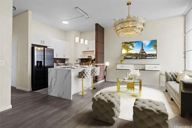 a living room with stainless steel appliances kitchen island furniture and a chandelier