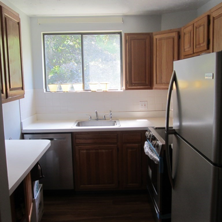 120 Fellsview Road, Unit 124 Stoneham, MA 02180 - Photo 11 of 20 a kitchen with a sink a refrigerator and window