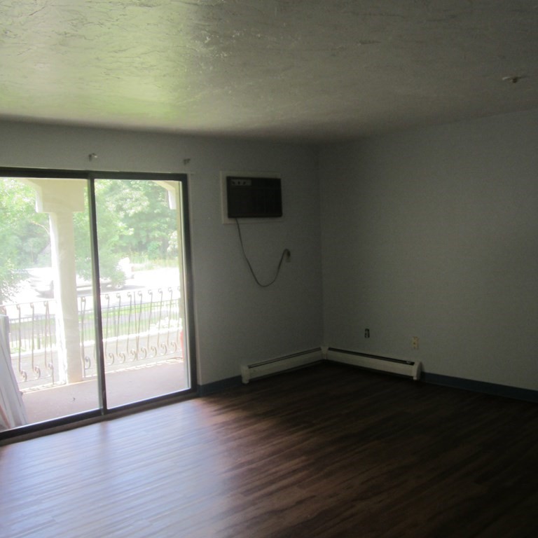 120 Fellsview Road, Unit 124 Stoneham, MA 02180 - Photo 3 of 20 a view of empty room with wooden floor and fan