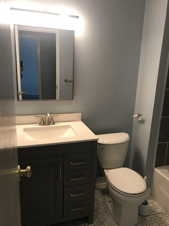 120 Fellsview Road, Unit 124 Stoneham, MA 02180 - Photo 8 of 20 a bathroom with a toilet sink and mirror