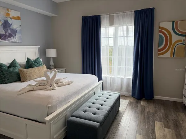 a bed sitting in a bedroom next to a window