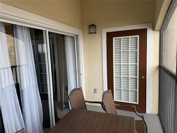 a view of a balcony with chair and front door