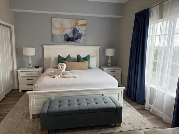 a bedroom with a bed and a window