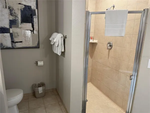 a bathroom with a toilet and a shower