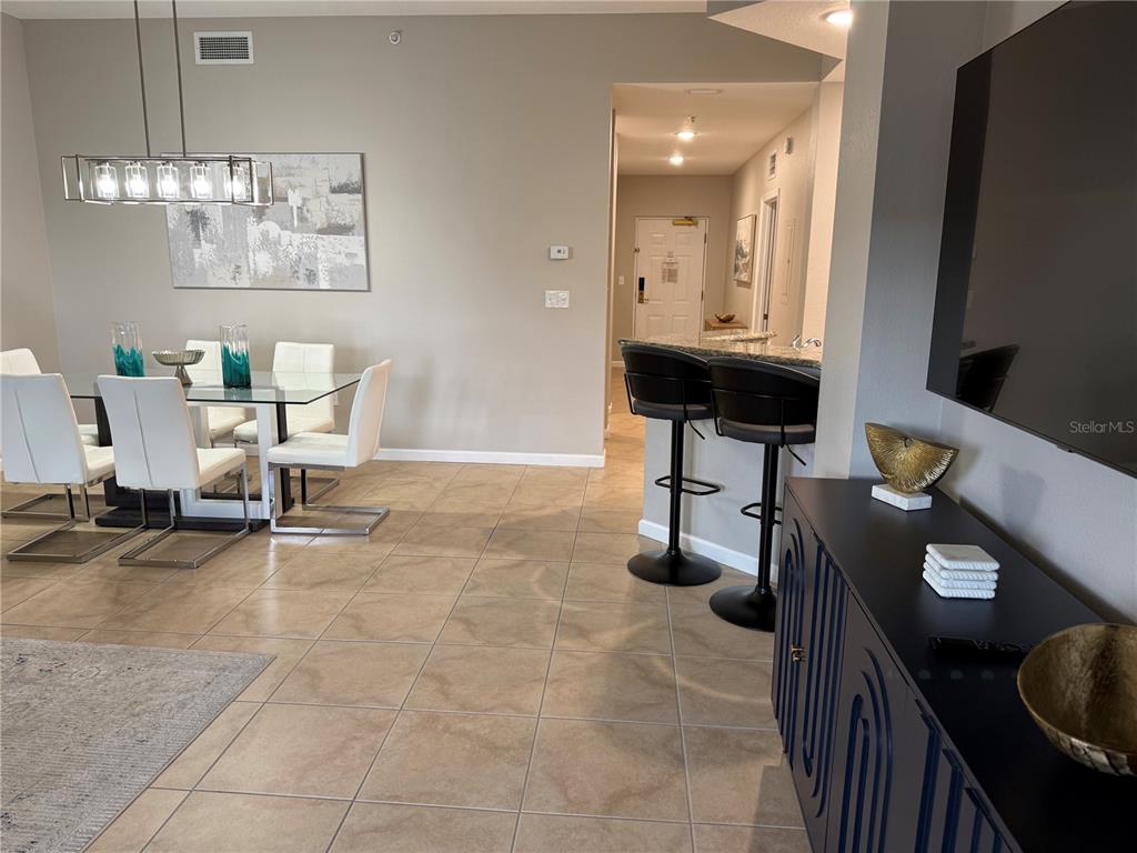 8762 Worldquest Boulevard, Unit 6504 Orlando, FL 32821 - Photo 19 of 45 a view of a workspace with furniture and chandelier