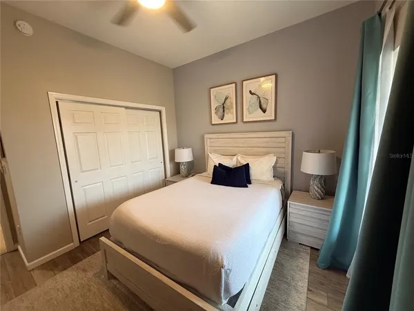 a bedroom with a bed and a chandelier