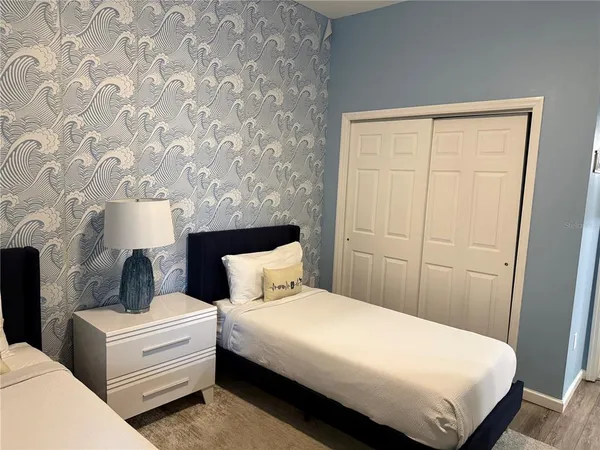 a bedroom with bed and a window