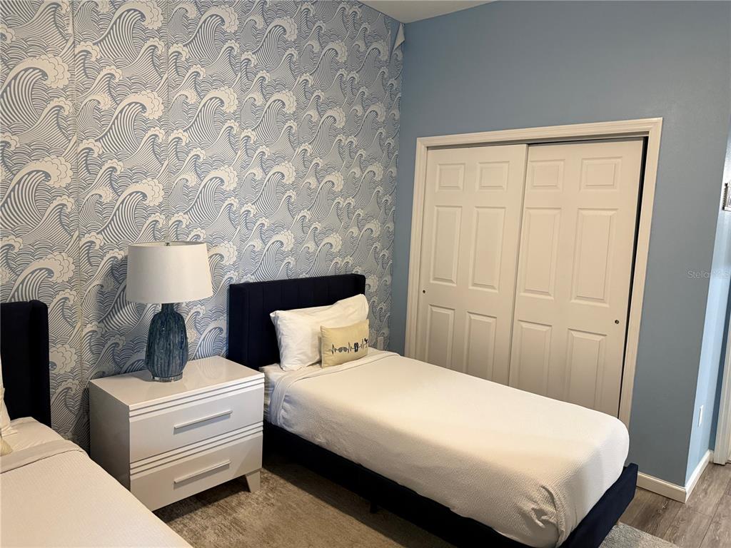 8762 Worldquest Boulevard, Unit 6504 Orlando, FL 32821 - Photo 31 of 45 a bedroom with bed and a window