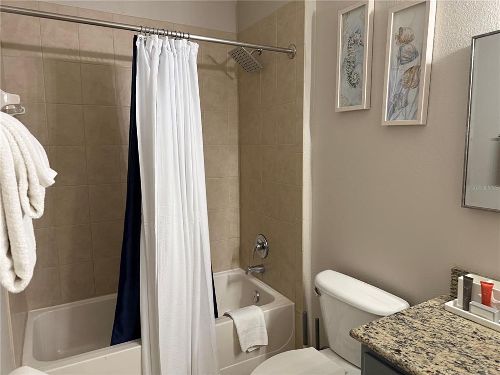 8762 Worldquest Boulevard, Unit 6504 Orlando, FL 32821 - Photo 33 of 45 a white toilet sitting next to a bathroom sink
