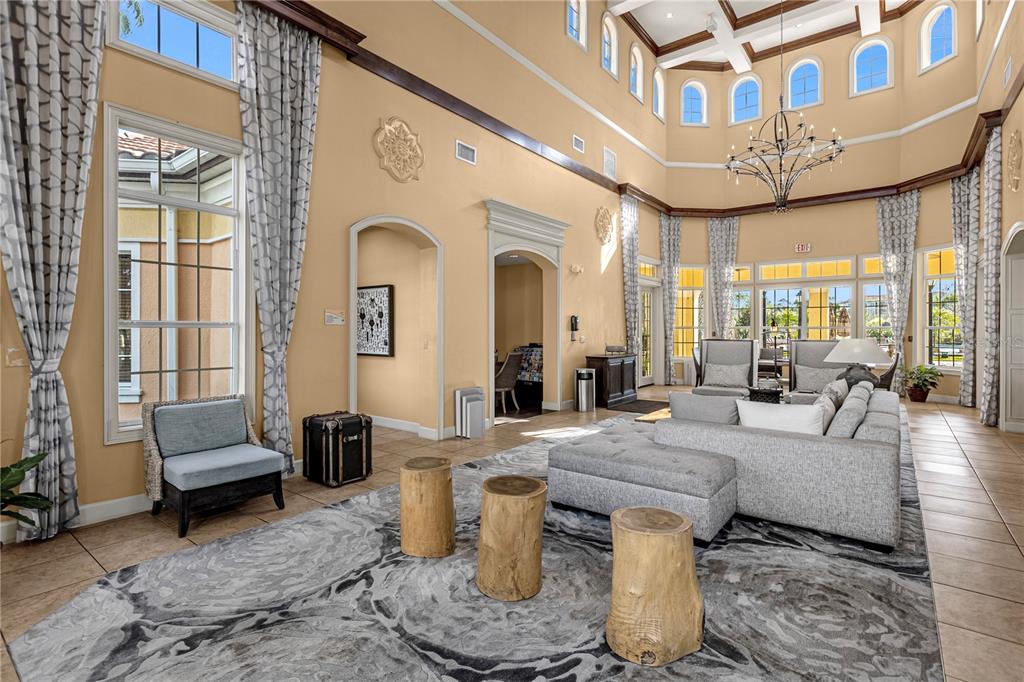 8762 Worldquest Boulevard, Unit 6504 Orlando, FL 32821 - Photo 35 of 45 a living room with furniture and a chandelier