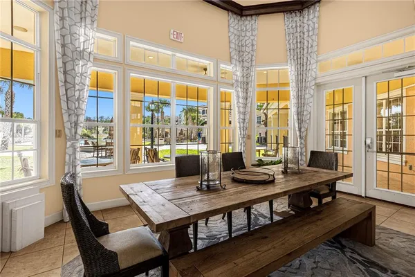 a view of a dining room with furniture large windows and wooden floor