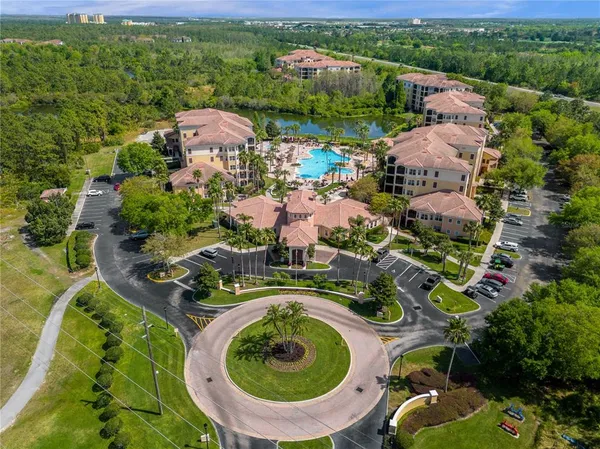 an aerial view of a house with a garden and lake view