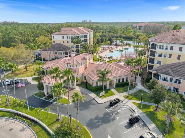an aerial view of residential houses with outdoor space and parking