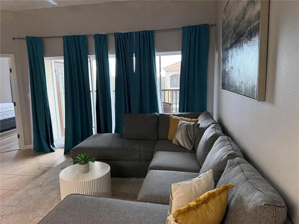 a living room with furniture and a large window