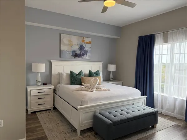 a bedroom with a bed and a chandelier