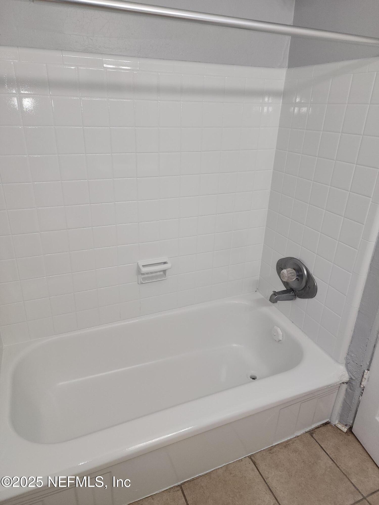 6151 Ardisia Road West Jacksonville, FL 32209 - Photo 14 of 18 a white bath tub and a shower