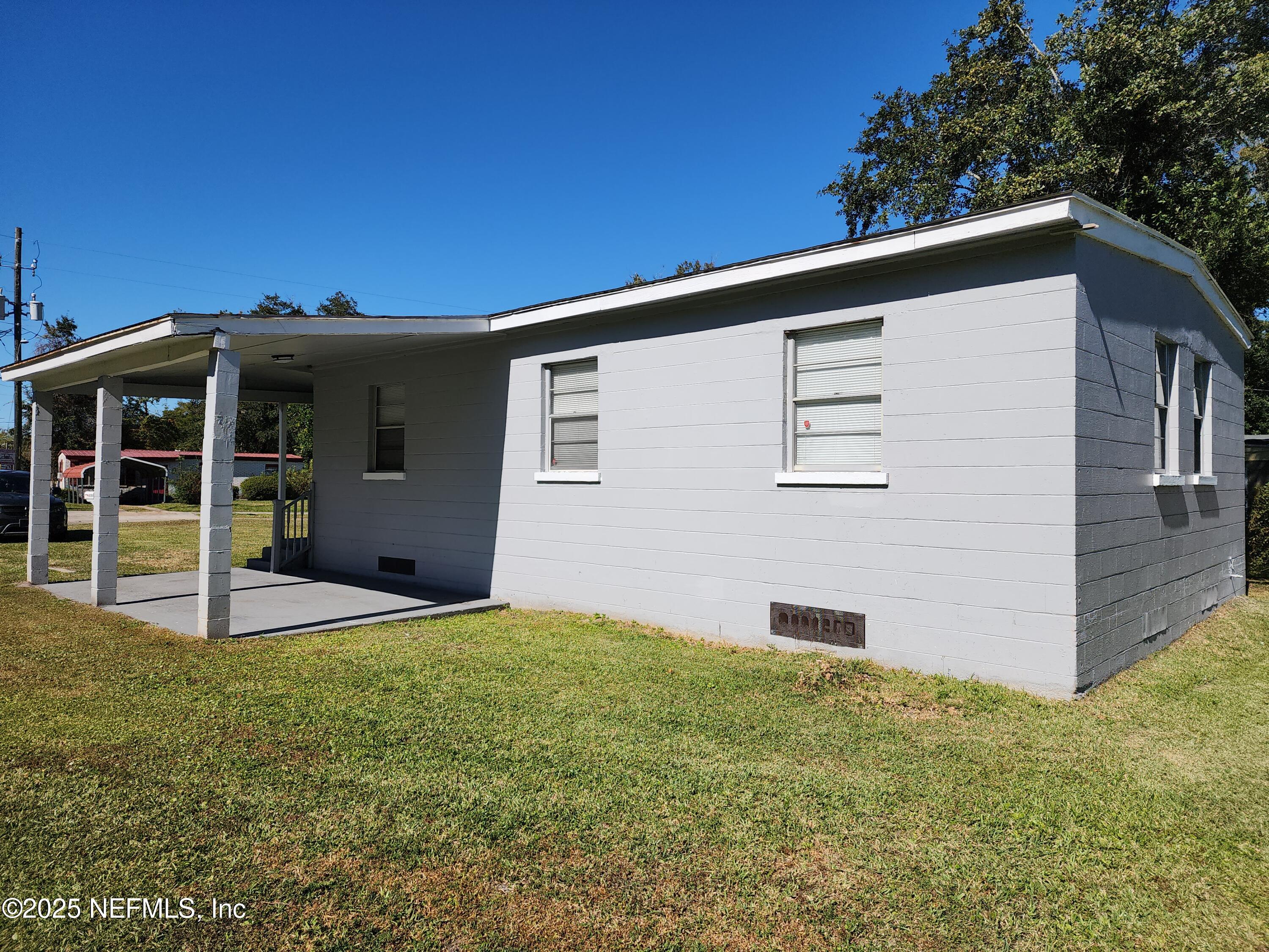 6151 Ardisia Road West Jacksonville, FL 32209 - Photo 18 of 18 a backyard of a house with lots of green space