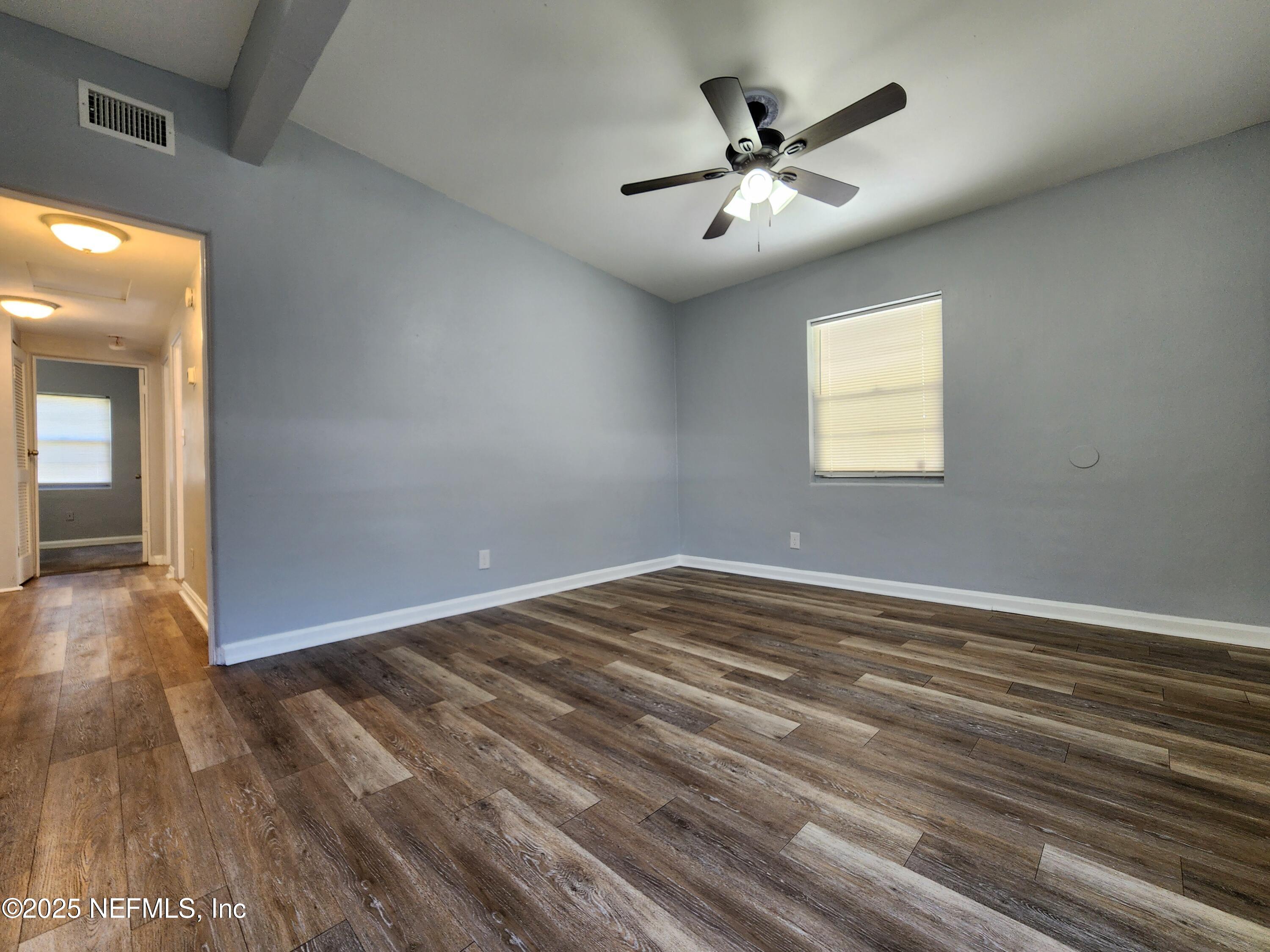 6151 Ardisia Road West Jacksonville, FL 32209 - Photo 4 of 18 wooden floor in an empty room with a window