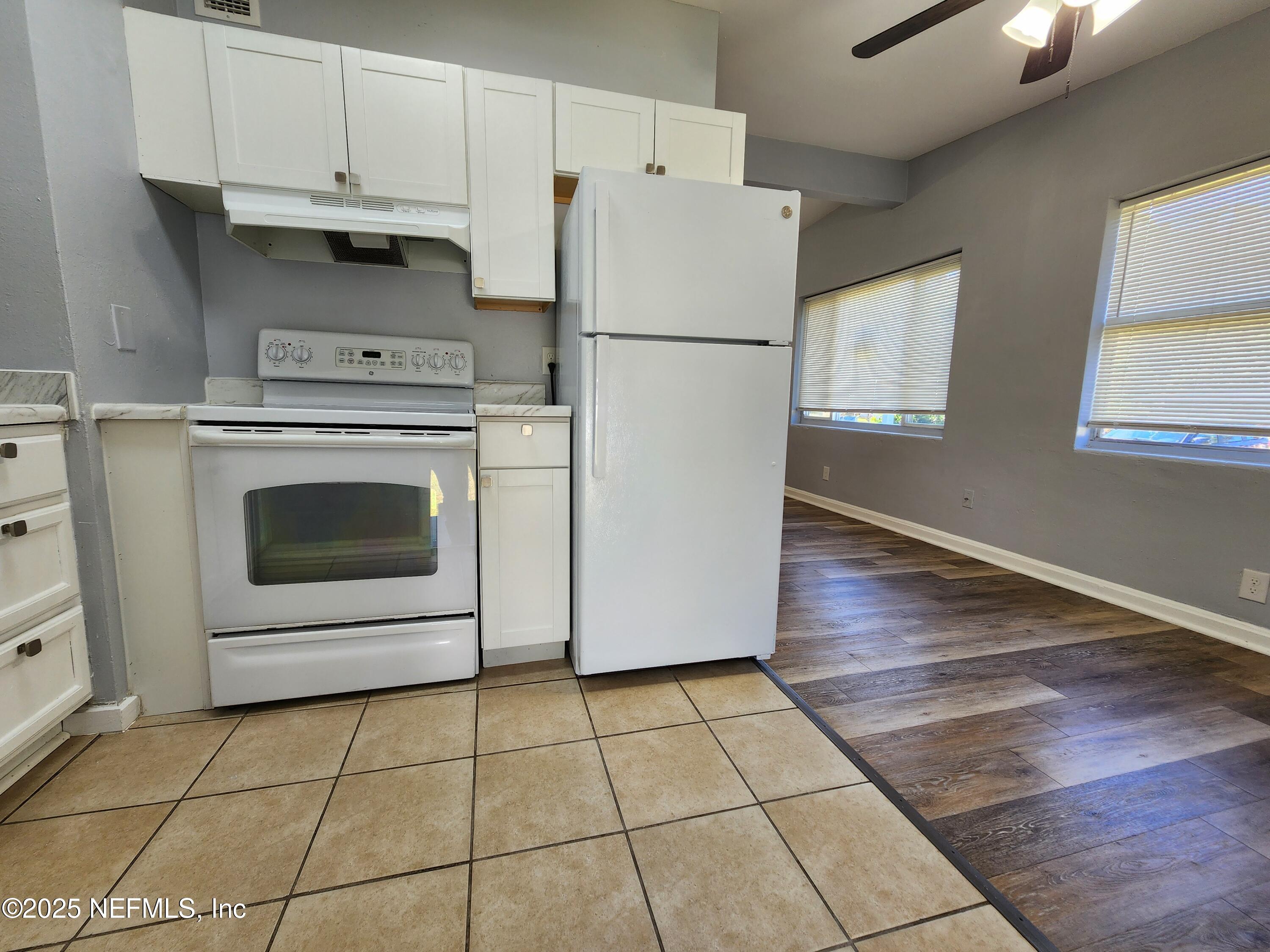 6151 Ardisia Road West Jacksonville, FL 32209 - Photo 7 of 18 a white refrigerator freezer and a stove sitting inside of a kitchen