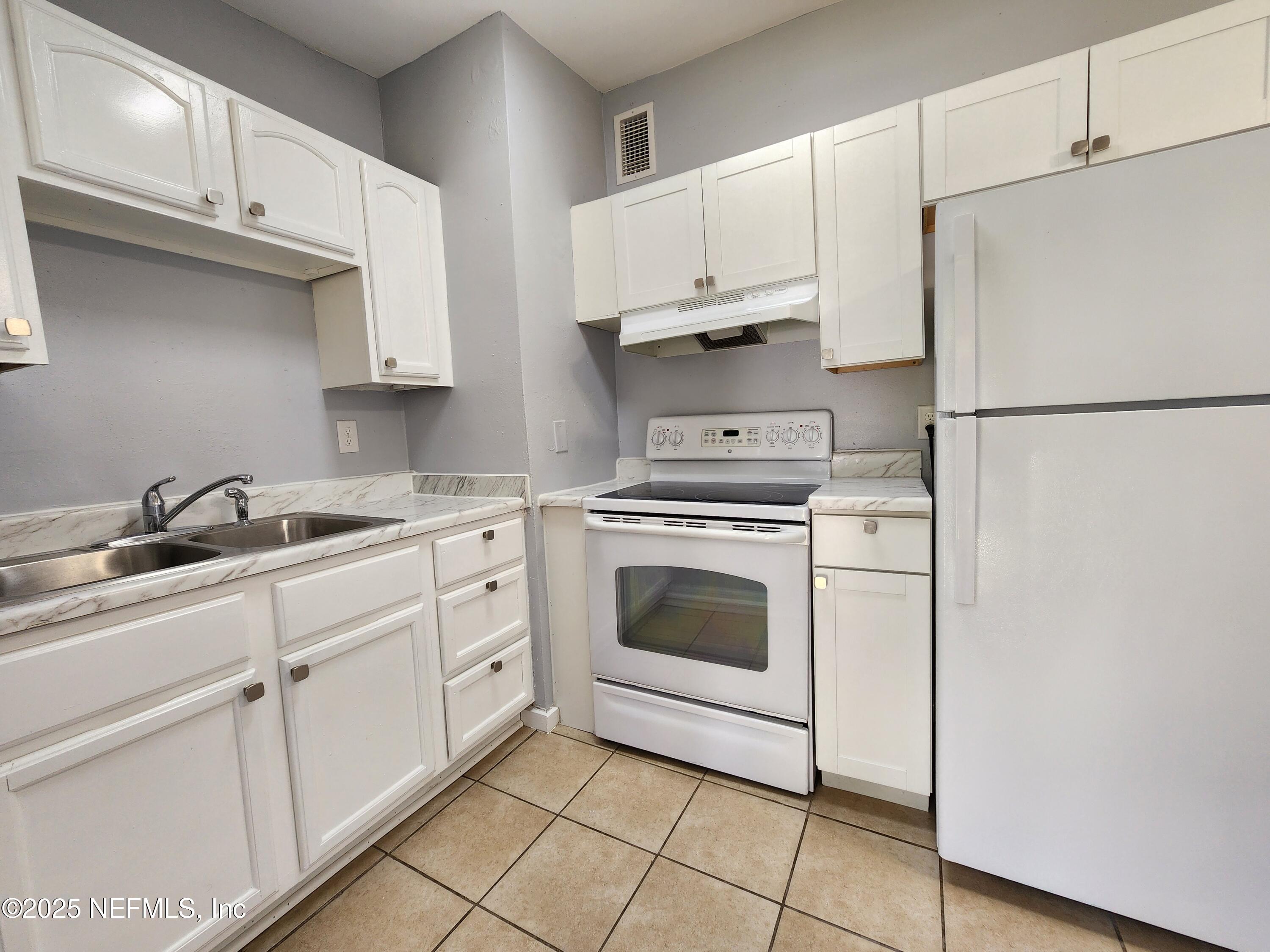 6151 Ardisia Road West Jacksonville, FL 32209 - Photo 8 of 18 a kitchen with cabinets stainless steel appliances and a sink