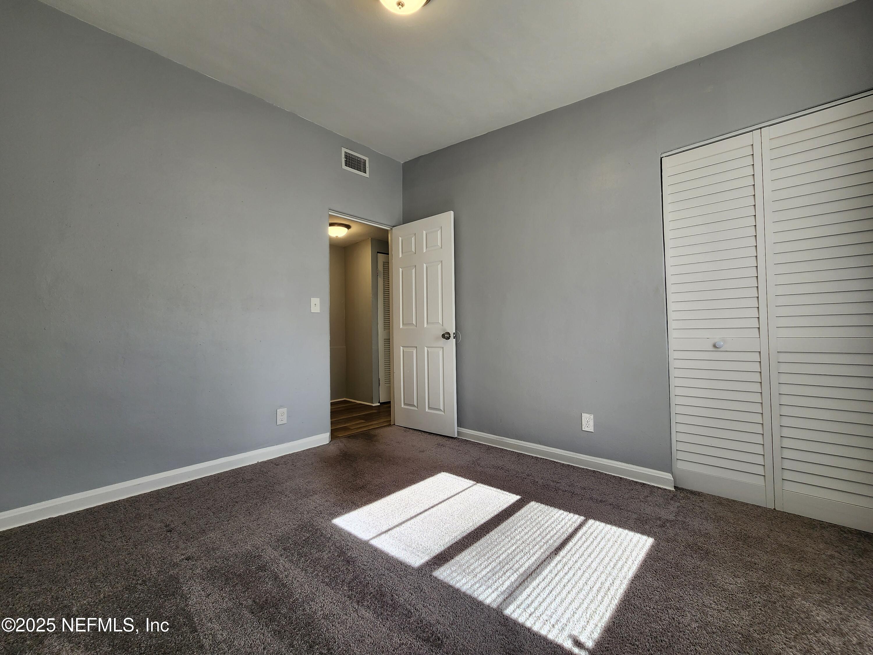6151 Ardisia Road West Jacksonville, FL 32209 - Photo 9 of 18 an empty room with an entryway