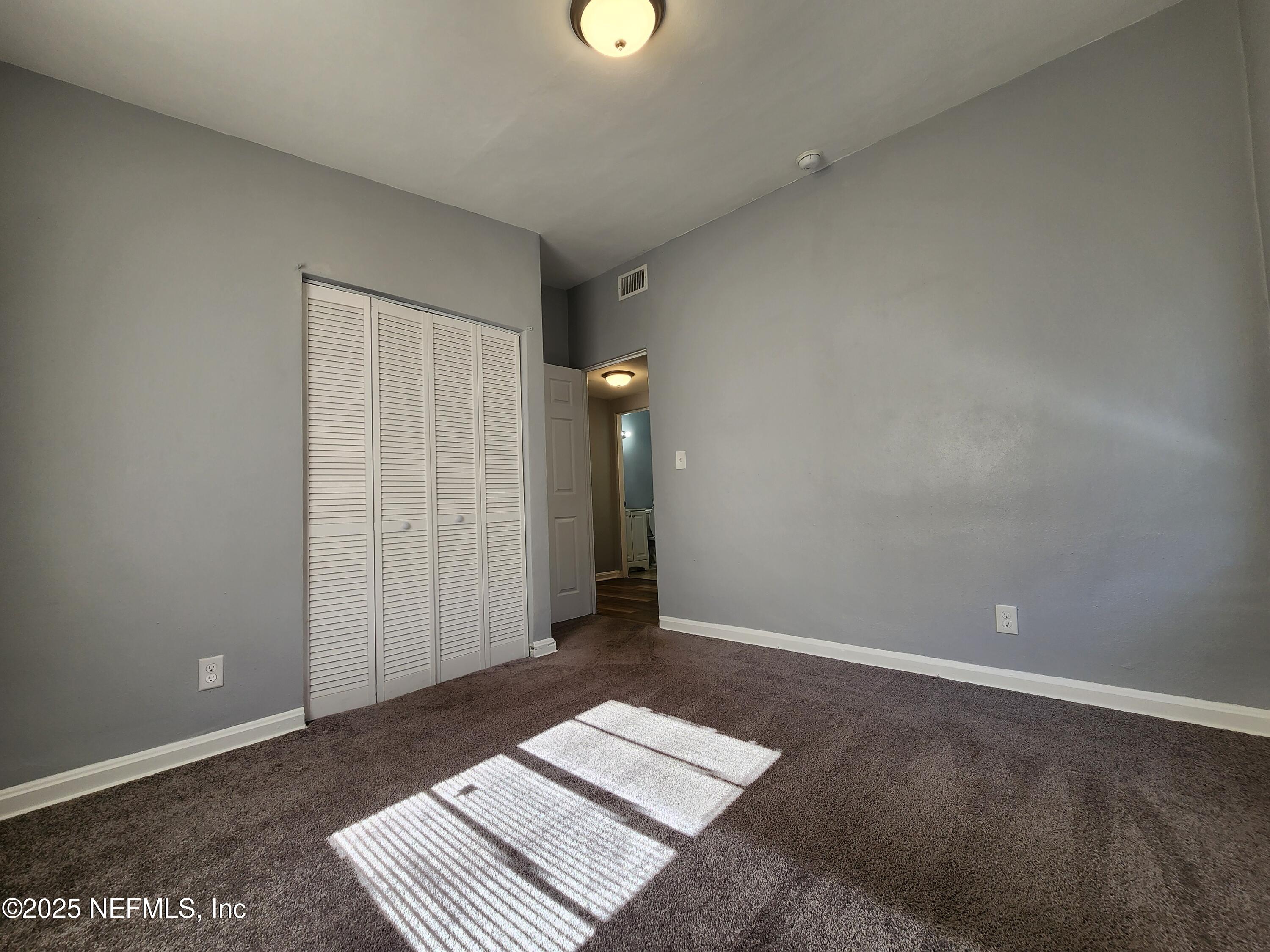 6151 Ardisia Road West Jacksonville, FL 32209 - Photo 10 of 18 an empty room with an entryway