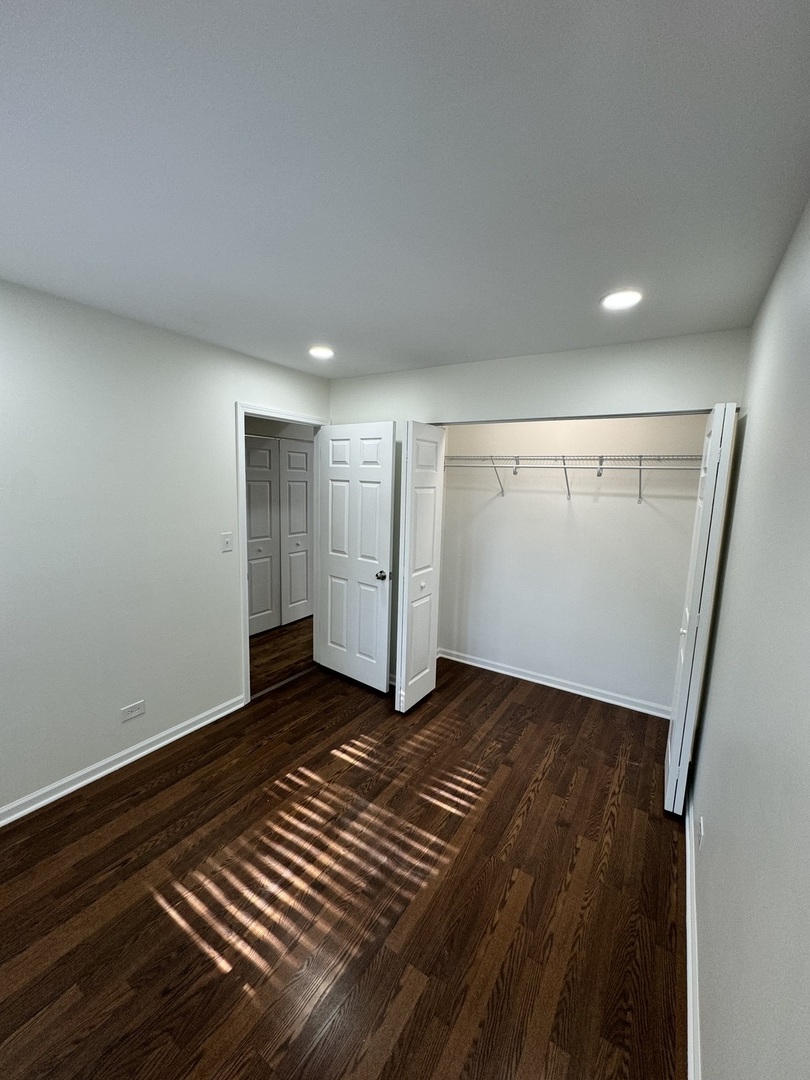 1944 Navarone Drive Naperville, IL 60565 - Photo 5 of 6 a view of an empty room with wooden floor and closet