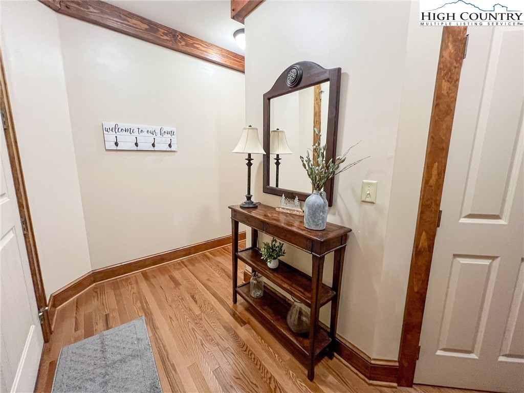 164 Evening View Lane, Unit CB2 Boone, NC 28607 - Photo 3 of 23 a view of a hallway with wooden floor and stairs