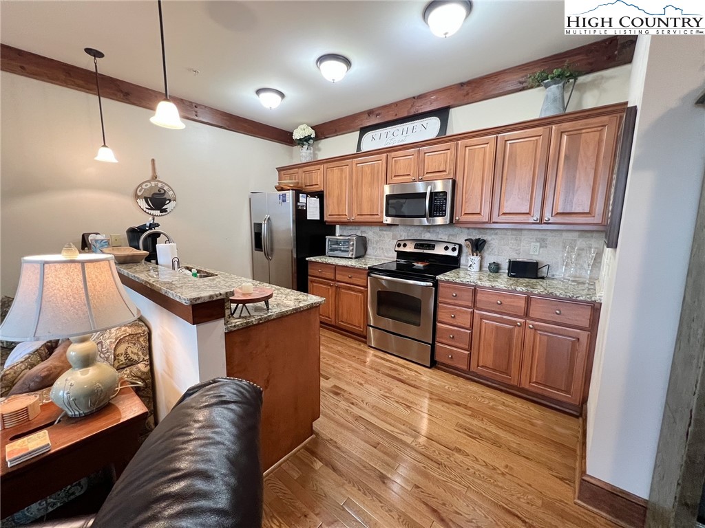 164 Evening View Lane, Unit CB2 Boone, NC 28607 - Photo 4 of 23 a kitchen with stainless steel appliances granite countertop a stove sink and cabinets
