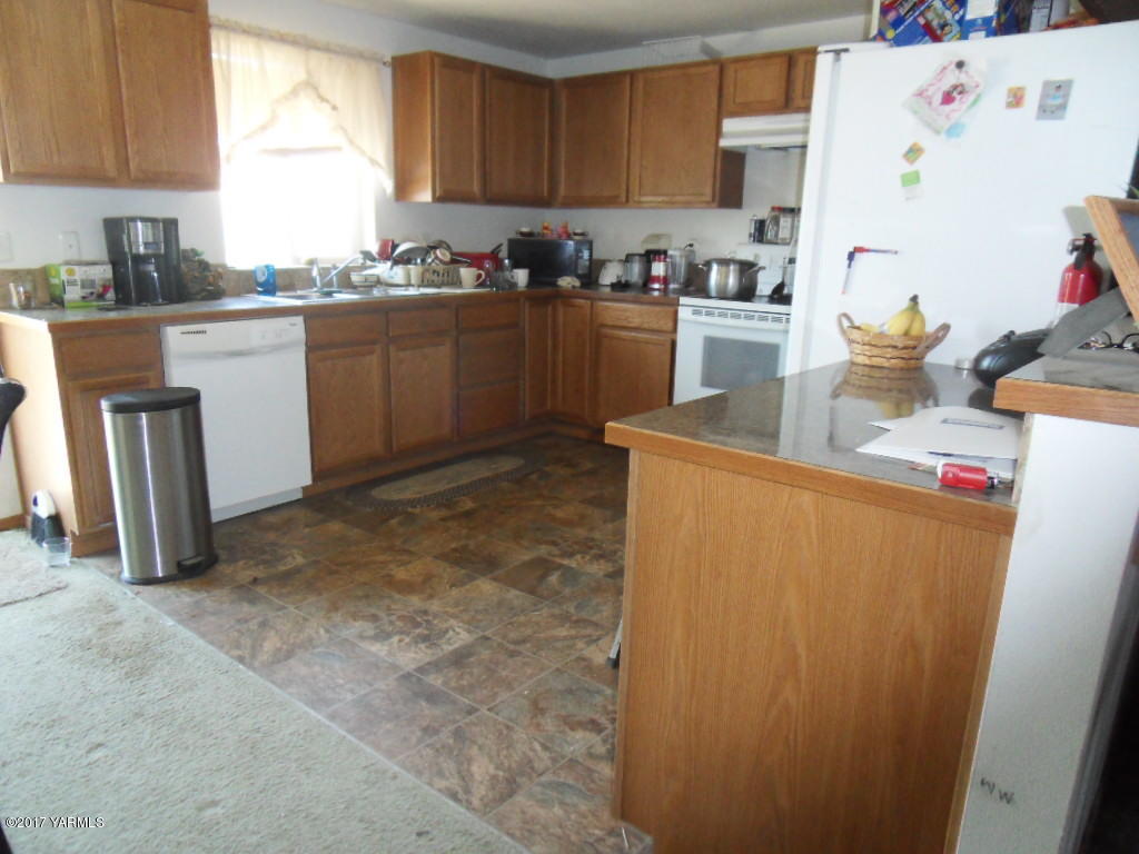 2708 Birchfield Road Yakima, WA 98901 - Photo 4 of 13 a kitchen with stainless steel appliances granite countertop a refrigerator sink and stove