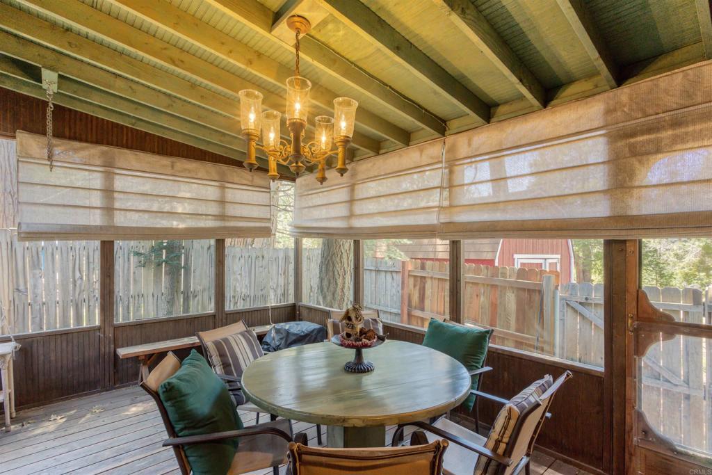 21868 Crestline Road Palomar Mountain, CA 92060 - Photo 18 of 26 a view of a dining room with furniture wooden floor and a chandelier