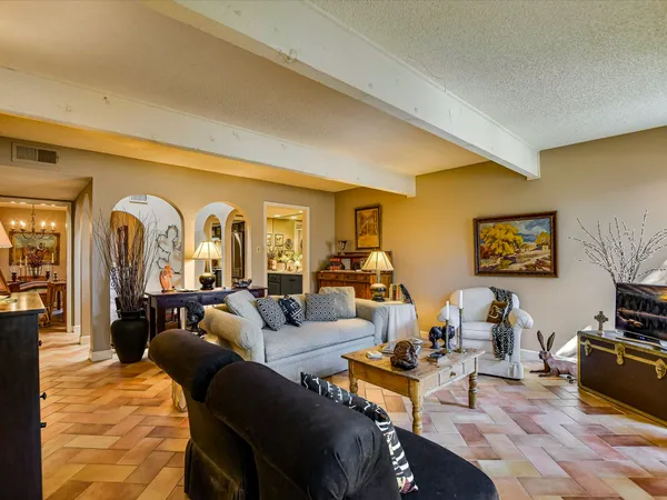 a living room with furniture fireplace and a flat screen tv