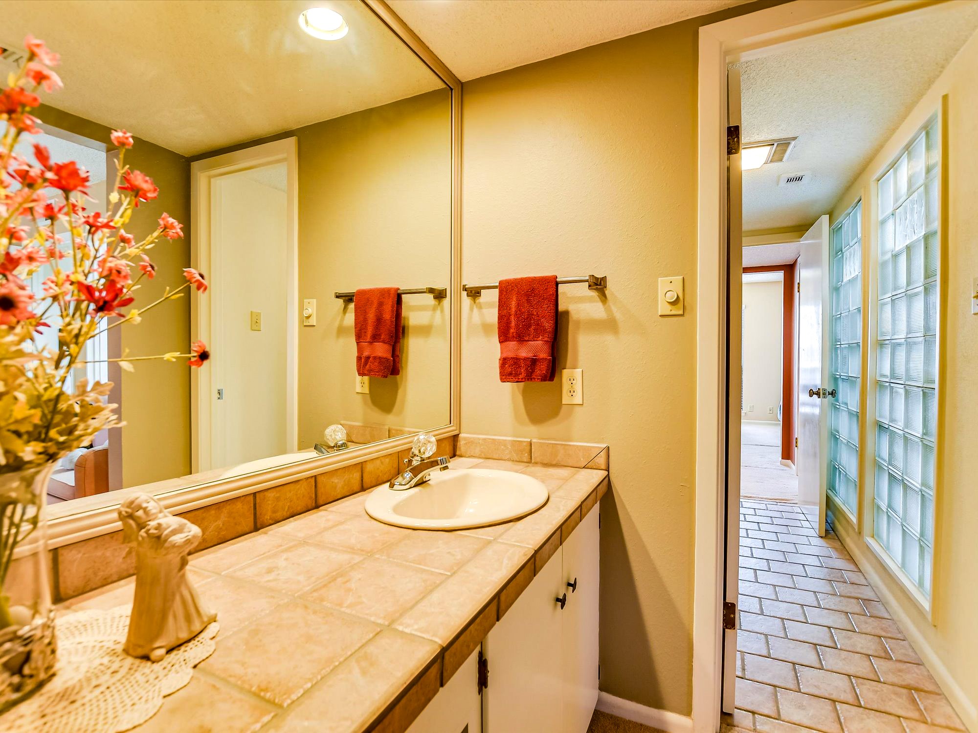 3500 Enfield Road, Unit E Austin, TX 78703 - Photo 18 of 20 a bathroom with a sink and a mirror