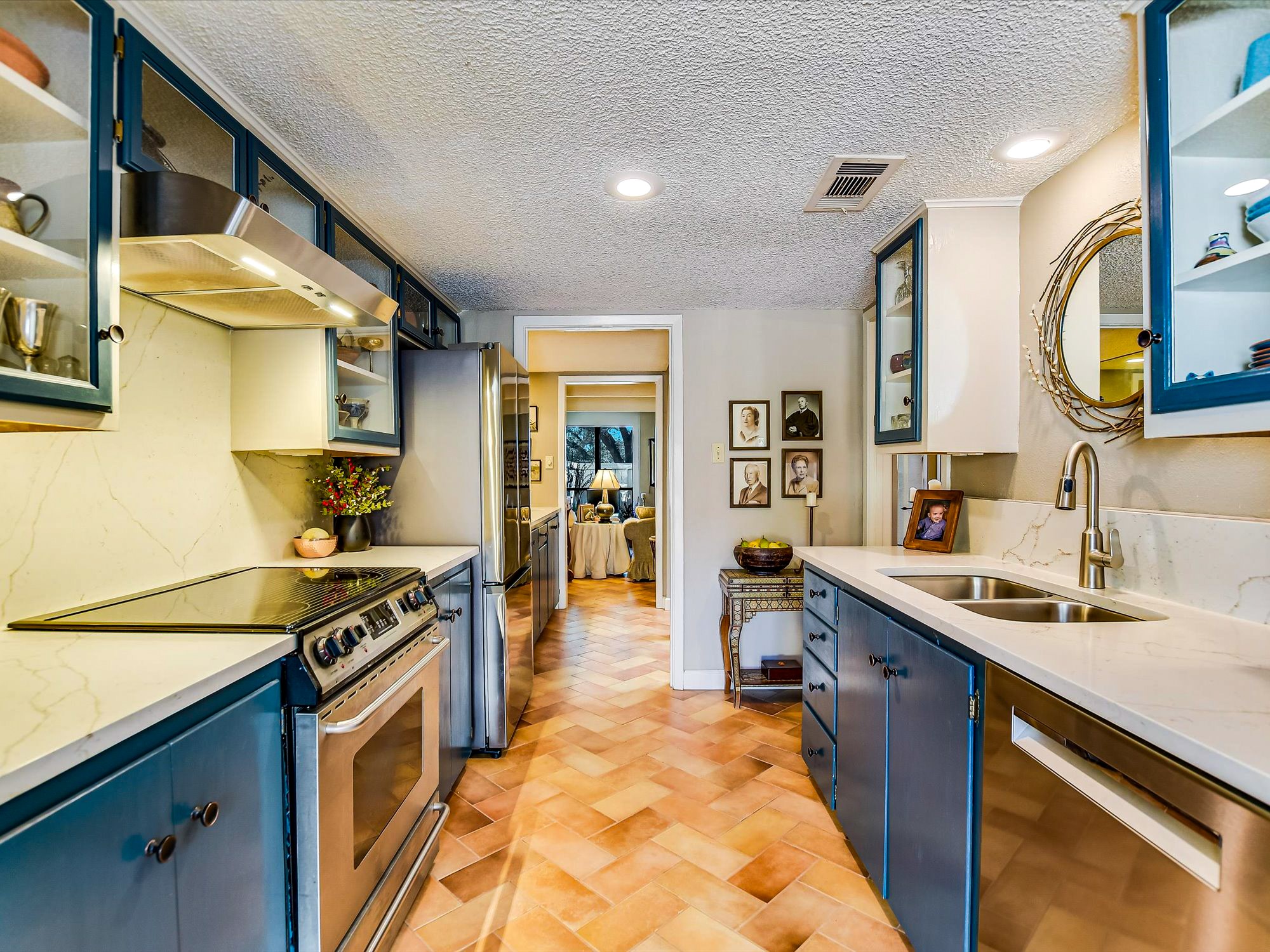3500 Enfield Road, Unit E Austin, TX 78703 - Photo 7 of 20 a kitchen with stainless steel appliances granite countertop a stove a sink and a microwave