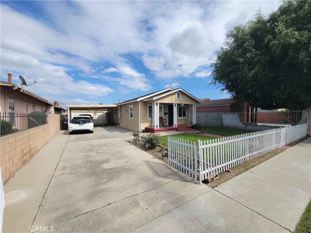 15334 Orizaba Avenue Paramount, CA 90723 - Photo 1 of 16 a front view of a house with garden