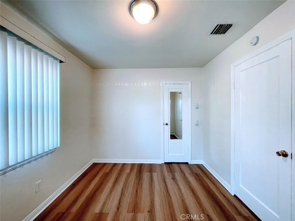 15334 Orizaba Avenue Paramount, CA 90723 - Photo 7 of 16 a view of empty room with wooden floor