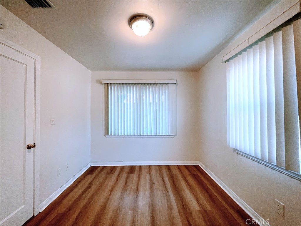 15334 Orizaba Avenue Paramount, CA 90723 - Photo 8 of 16 a view of an empty room with wooden floor and a window