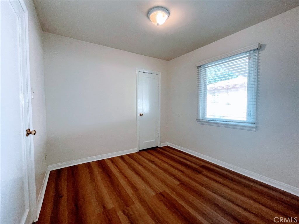 15334 Orizaba Avenue Paramount, CA 90723 - Photo 10 of 16 a view of an empty room with wooden floor and a window