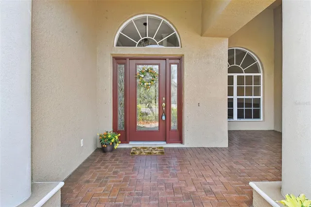 a kitchen with stainless steel appliances granite countertop a stove top oven a refrigerator a sink and a chairs