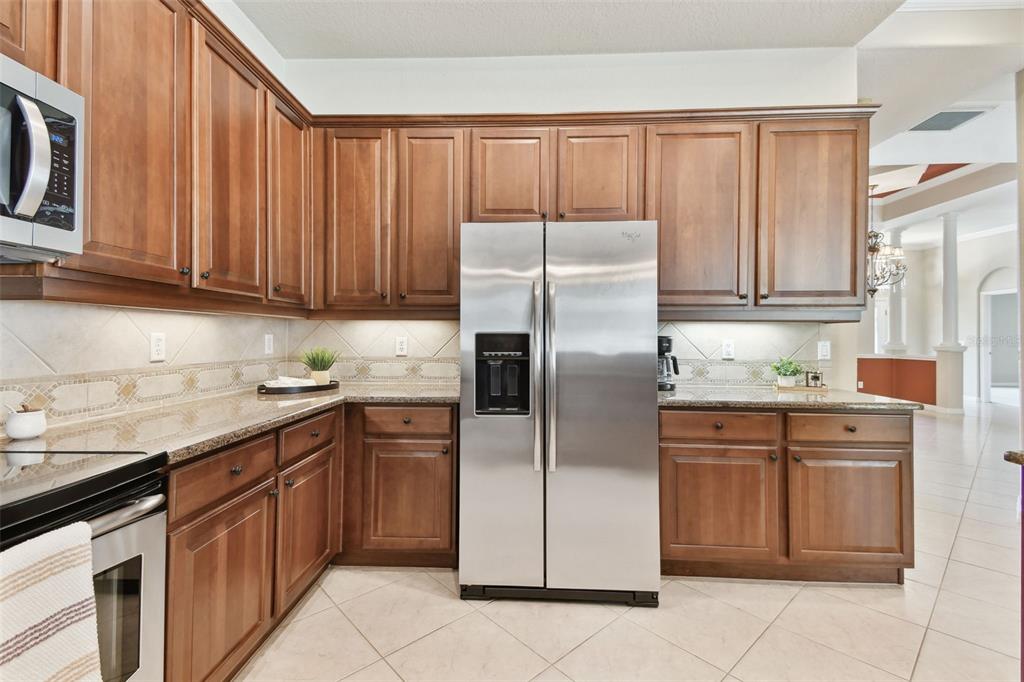 9008 Brookfield Terrace Bradenton, FL 34212 - Photo 24 of 81 a kitchen with stainless steel appliances granite countertop a refrigerator sink and cabinets