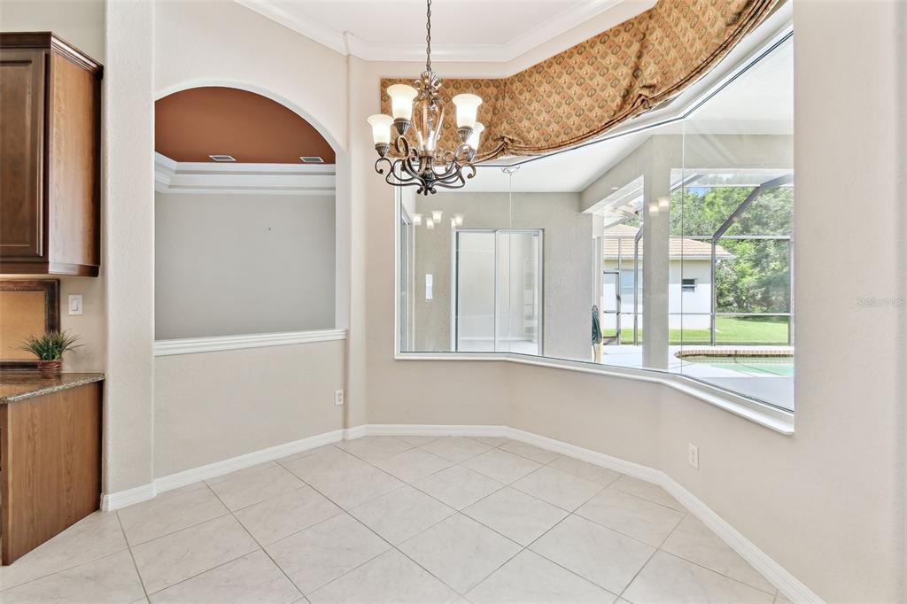 9008 Brookfield Terrace Bradenton, FL 34212 - Photo 25 of 81 a view of a livingroom with a chandelier fan and windows