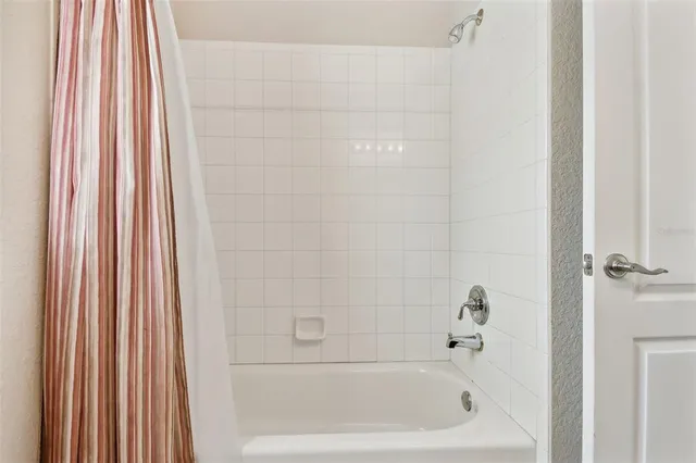 a spacious bathroom with a granite countertop sink a mirror and a shower