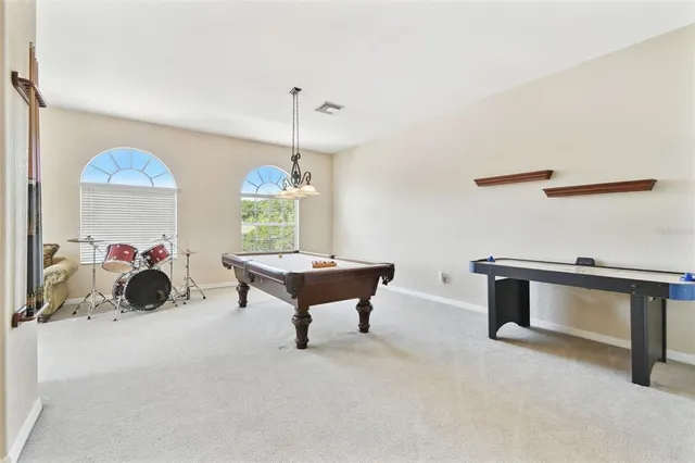 an aerial view of residential houses with outdoor space and ocean view