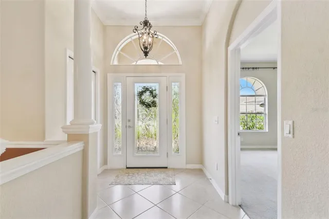 an empty room with windows ceiling fan and windows
