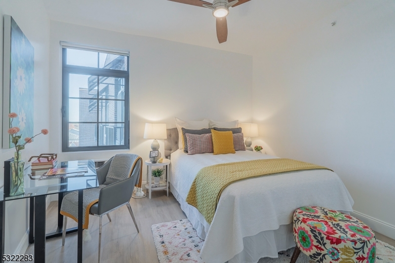 1026 Stuyvesant Avenue, Unit 403 Union, NJ 07083 - Photo 8 of 13 a bedroom with a bed and a table in it