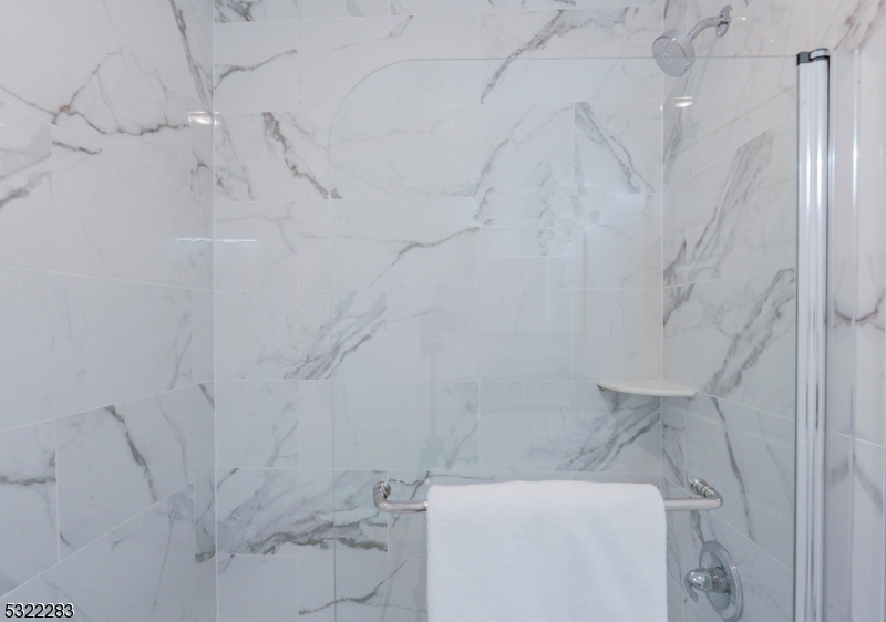 1026 Stuyvesant Avenue, Unit 403 Union, NJ 07083 - Photo 9 of 13 a bathroom with a toilet and a shower