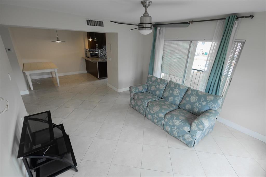 4152 Inverrary Drive, Unit 202 Lauderhill, FL 33319 - Photo 4 of 13 a living room with furniture and a window